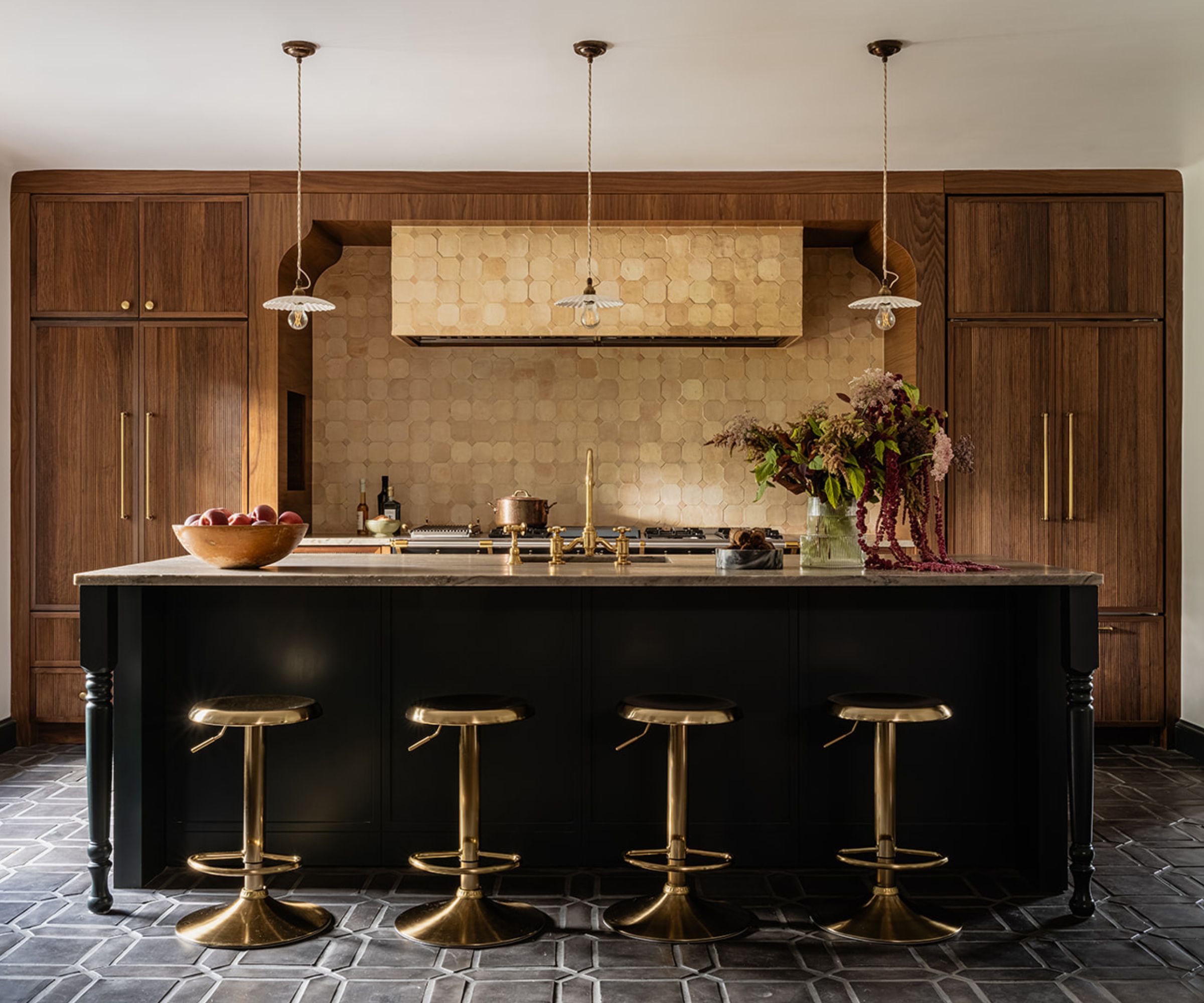 A large kitchen with wooden cabinets and a black island