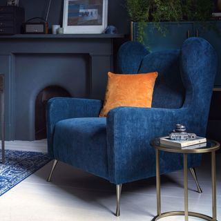 Navy blue velvet armchair in a navy blue living room
