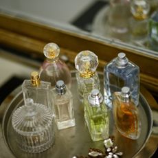 A collection of perfumes on a dressing table 