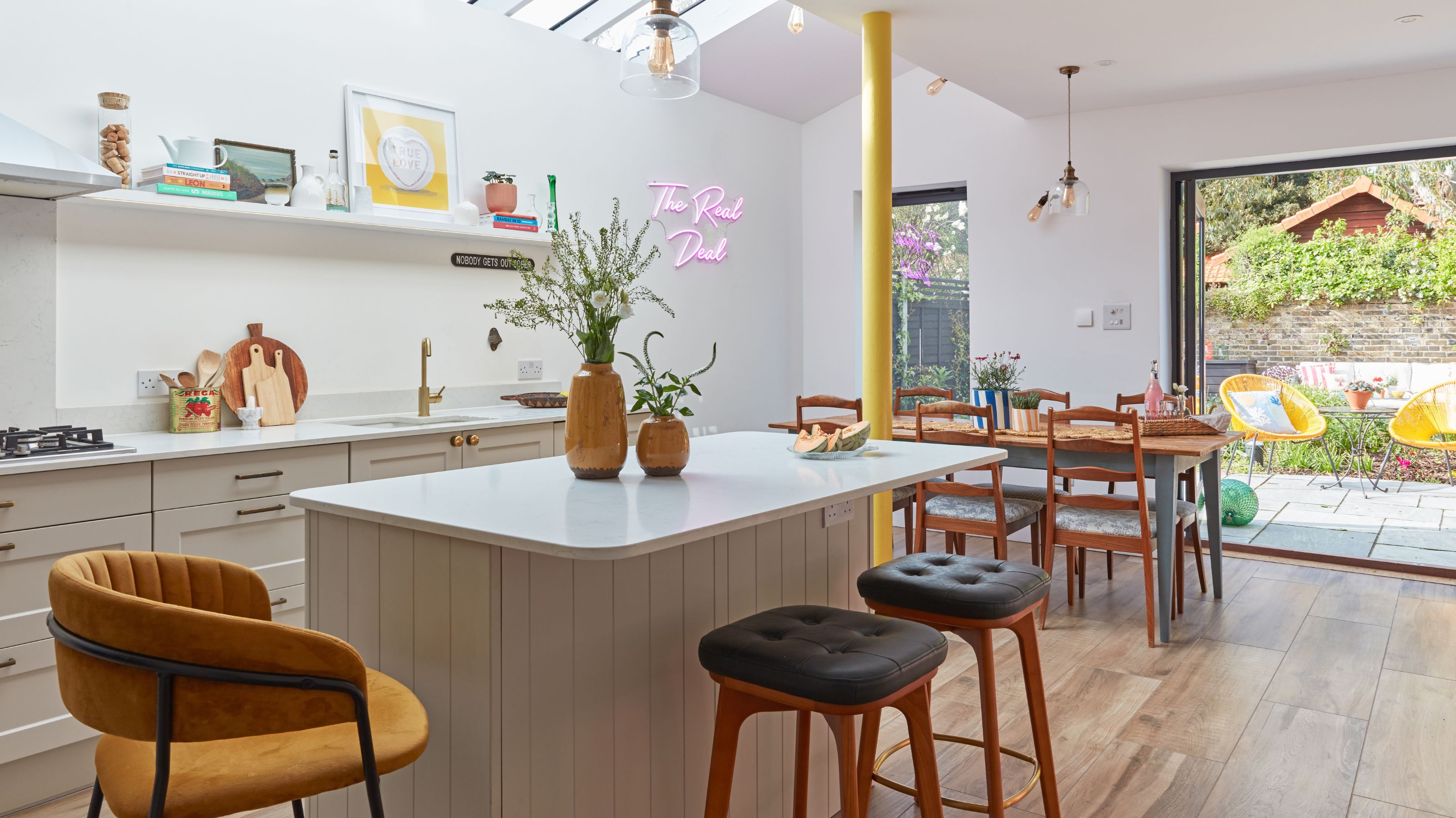 Open-plan kitchen and diner with a large kitchen island and wooden flooring