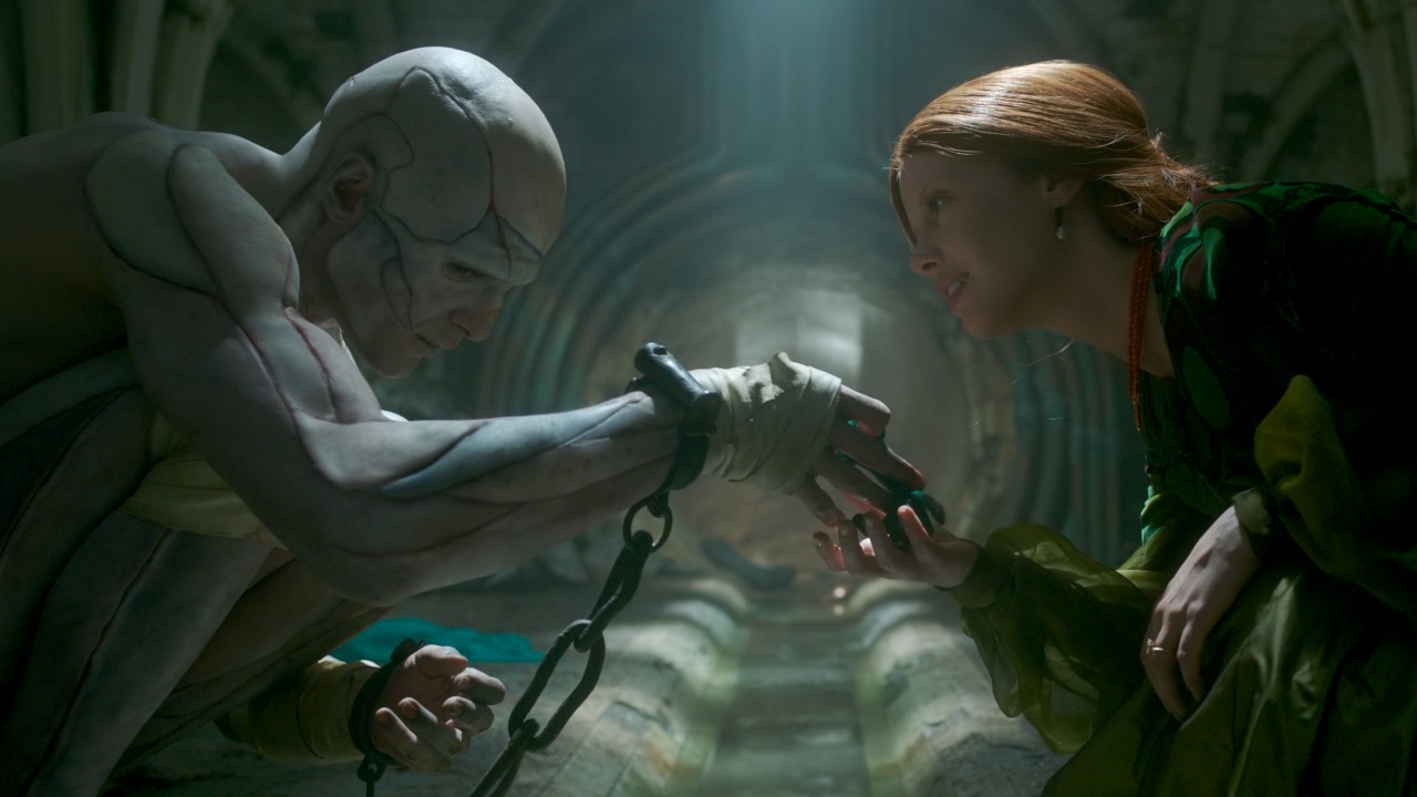 The Monster touching hands with Elizabeth