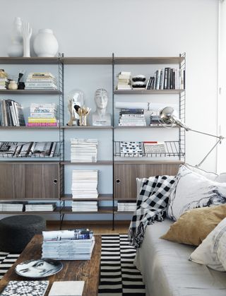 wall shelving unit with books on it in a living room