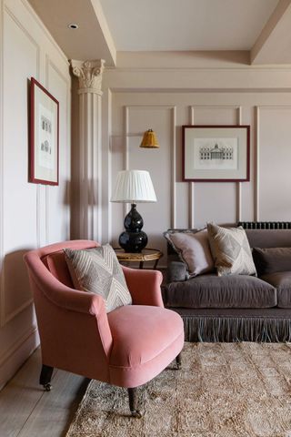 a living room with a pink accent chair