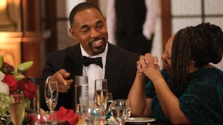 Jason George and Chandra Wilson as Ben and Miranda laughing in formal wear in Station 19 season 6