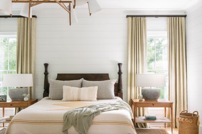 Rustic modern farmhouse bedroom with brown bed and white walls