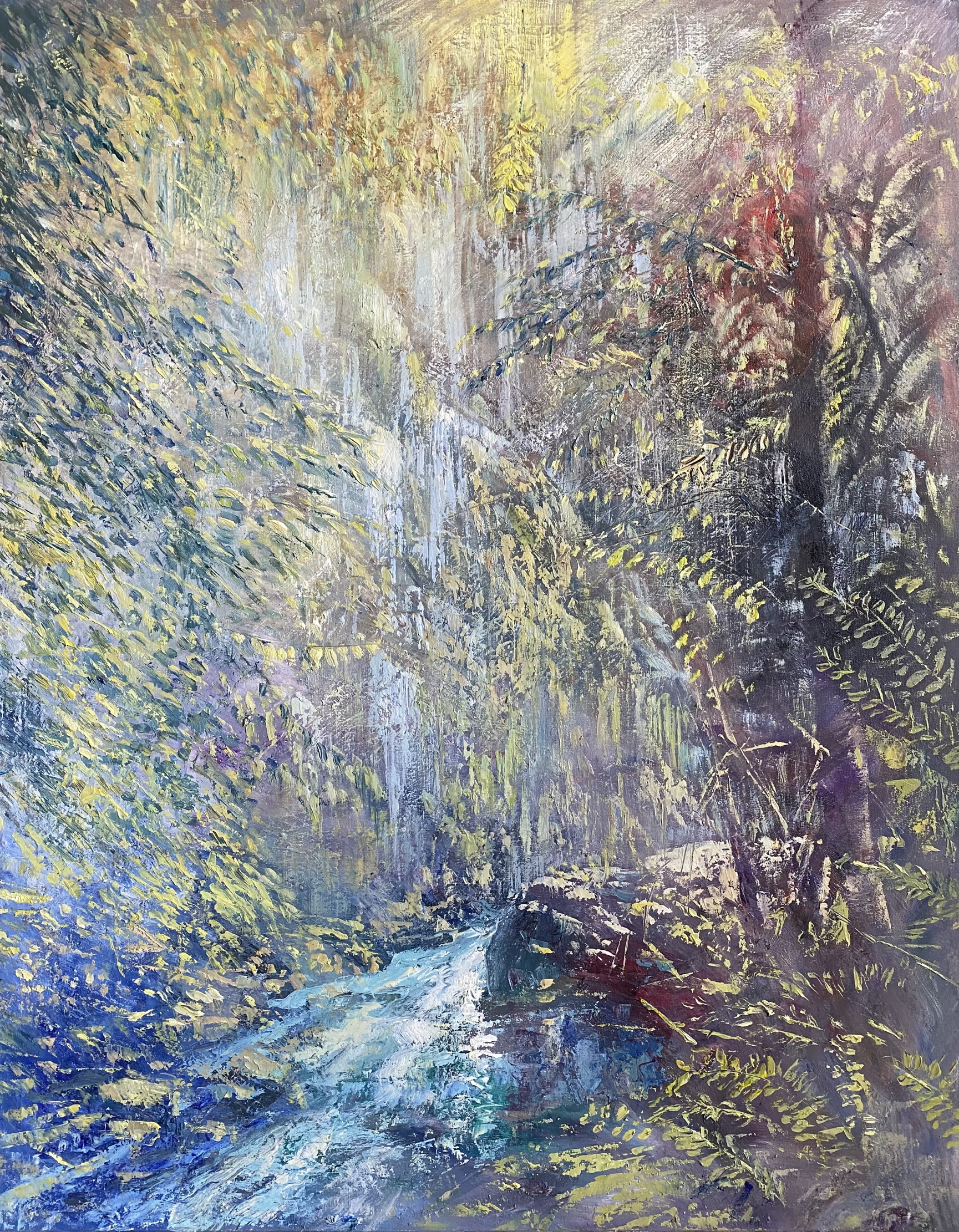Sunlight glows through the woods of Qadisha Waterfall