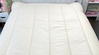 picture of woolroom mattress topper on mattress