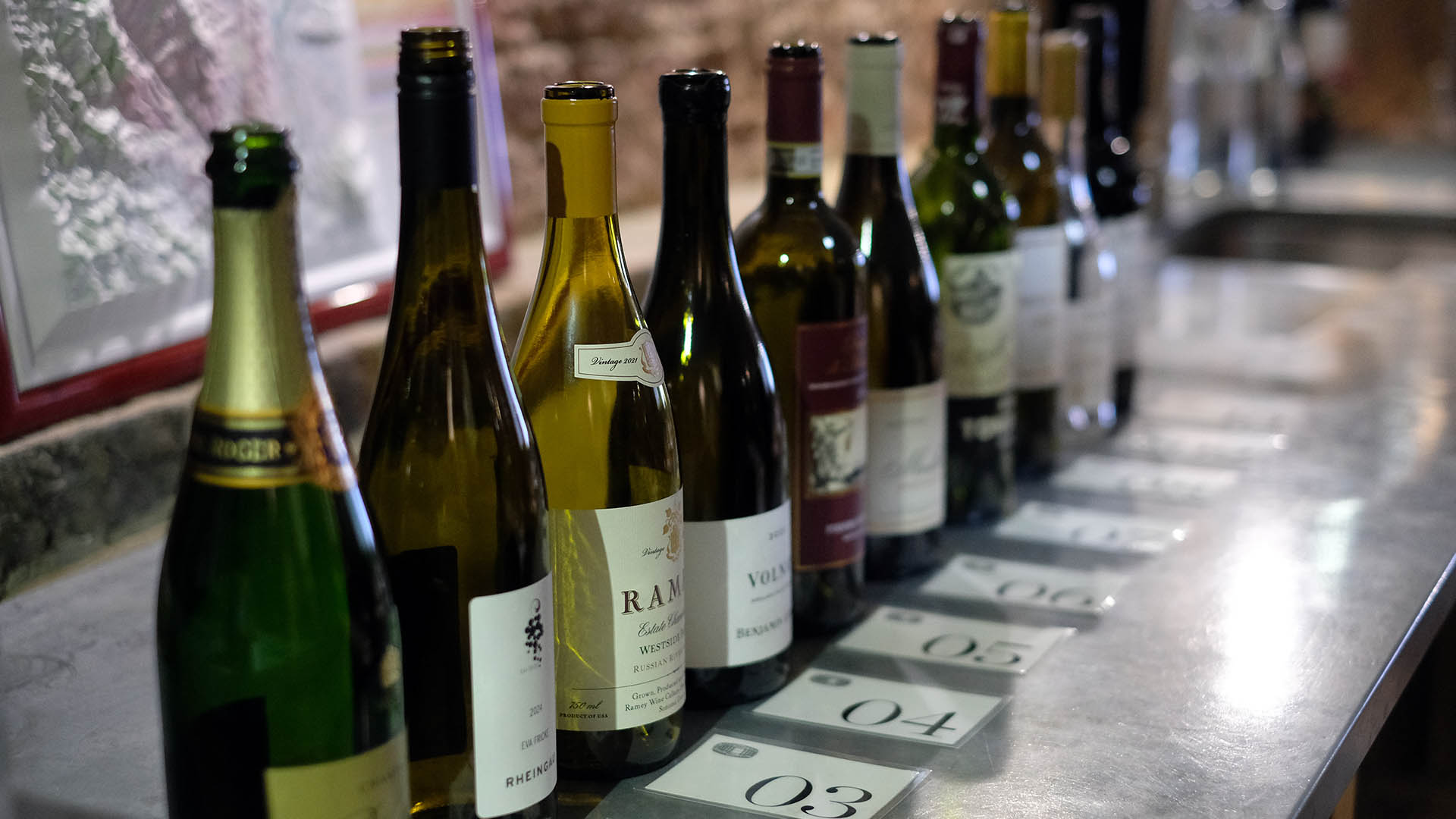 A photo of a line of wine bottles.