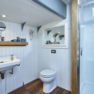 bathroom with wooden shelves and wooden flooring