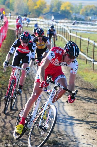 Brady Kappius (Clif Bar) leading a group of riders past the pits