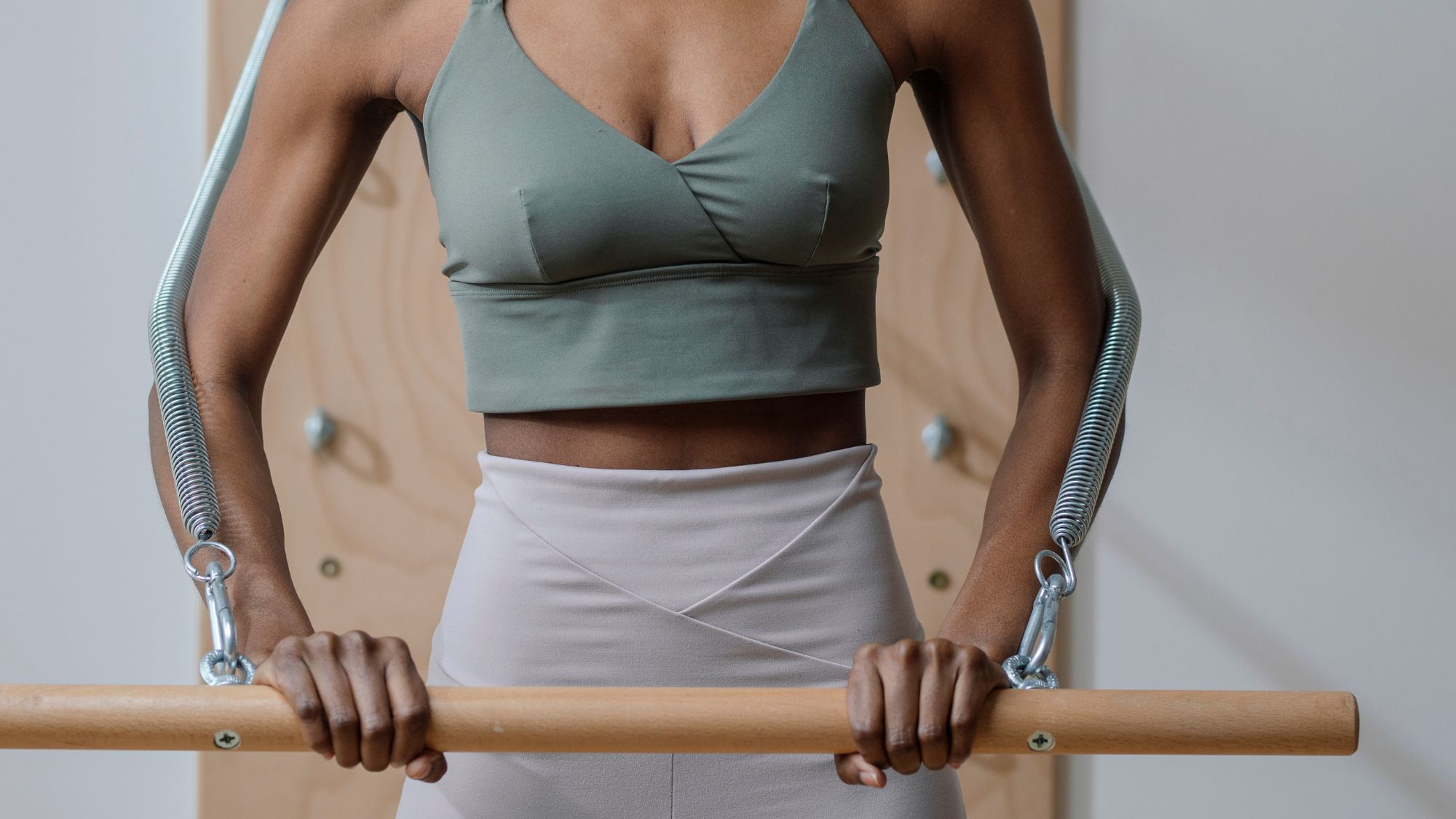 Woman trying out one of the best Pilates bars in a light and bright studio