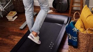 a photo of a man walking on the LifeSpan Under Desk Treadmill TR1200-DT3