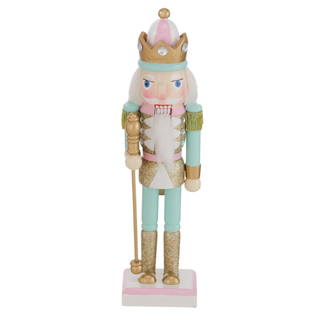 A pastel green, pink, and gold nutcracker