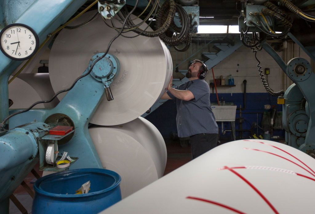 Worker loads newsprint