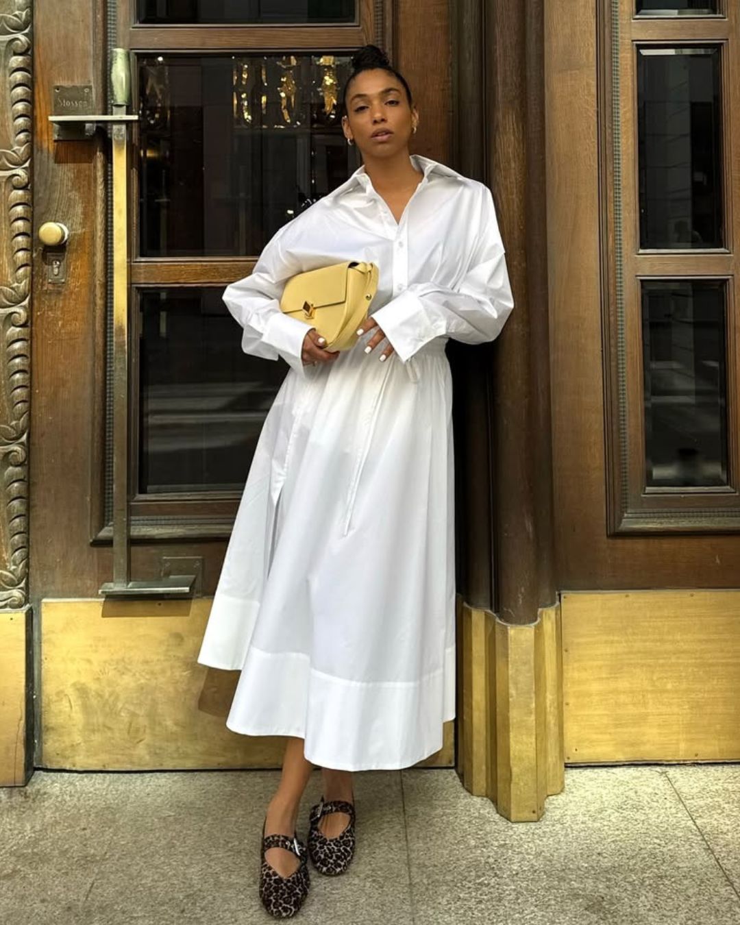 @cherifaakili wears a white skirt, midi skirt, leopard flats and yellow bag