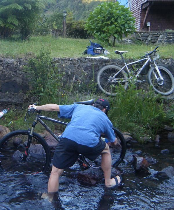 Mike Broderick washes his team's bikes.