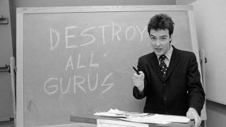 Jello Biafra in front of a chalkboard reading, "Destroy All Gurus"