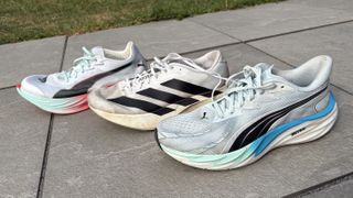 Puma Velocity Nitro 4, Adidas Evo SL & Puma Fast-R 3 on a sidewalk