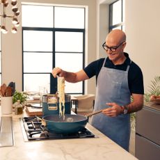 Stanley Tucci cooking with pan
