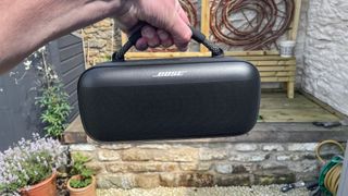 Bose SoundLink Max held by carry handle outside