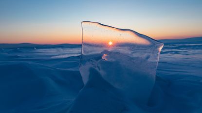 Beautiful sunrise sky over frozen water lake Baikal Siberia