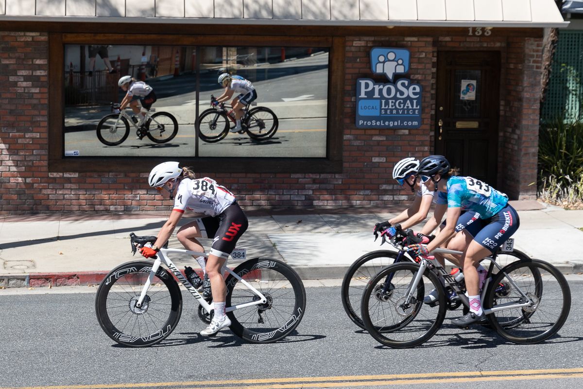 Cassidy Hickey (LUX-CTS p/b Specialized #384) Maeghan Easler (ATX Wolfpack p/b ProBikeKit #343), and Haley Smith (ATX Wolfpack p/b ProBikeKit #346 ) move down a narrow street on the backside of the course.