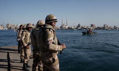 Egyptian soldiers guard the Suez Canal after the announcement of the final verdict in the case of the Port Said football massacre.