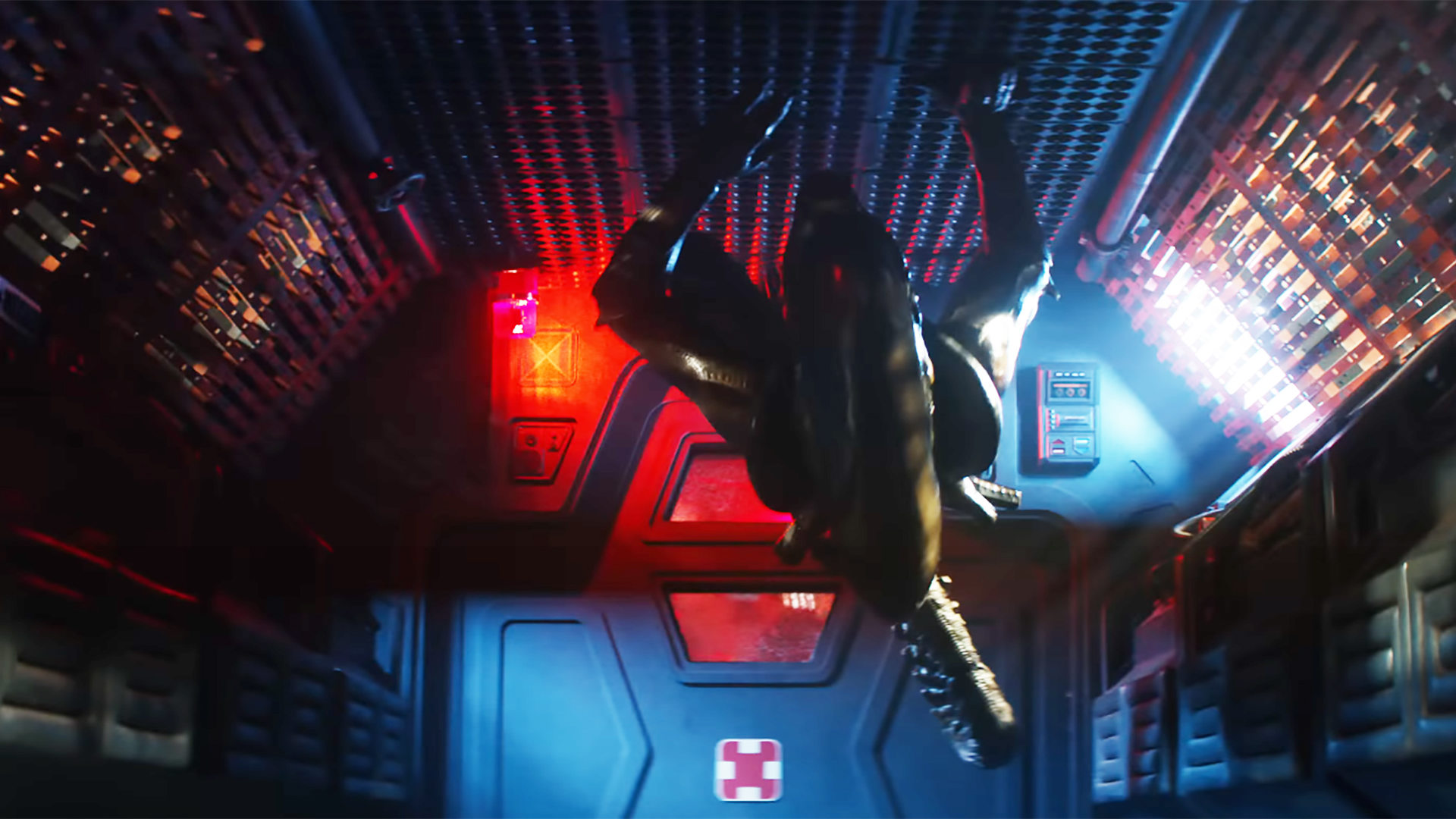 A xenomorph crawling on the ceiling of a dimly lit corridor in the trailer for Alien: Earth