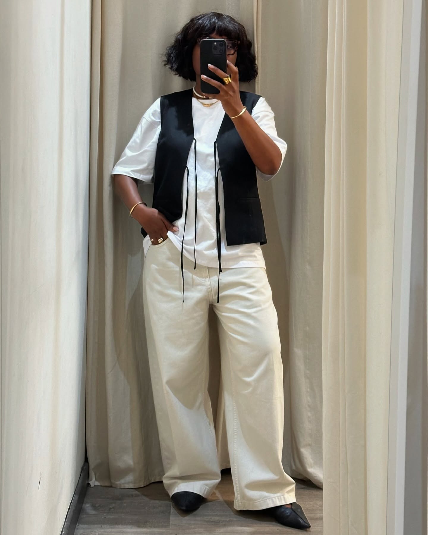 @frannfyne wearing tan denim, a white tee, and a vest