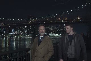 Louis Herthum as Monroe and Gabriel Basso as Peter Sutherland walking alongside the new york city waterfront in the night agent