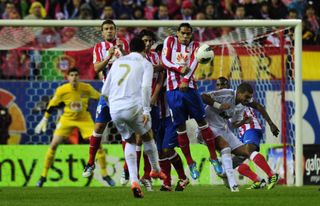 Cristiano Ronaldo scores a free-kick for Real Madrid against Atletico in 2012.