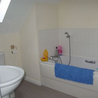 bathroom with partition wall and bath tub