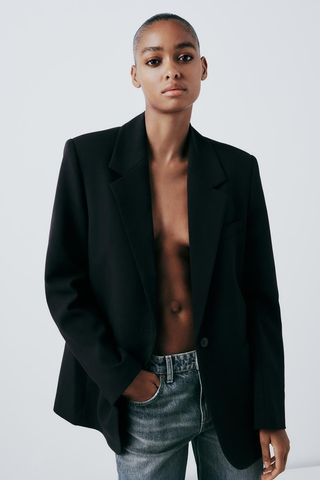 Zara model wearing black blazer and jeans