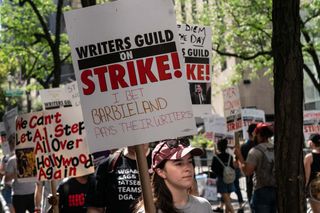 Striking members of Writers Guild of America picketing in front of NBC Universal on theme of Young Writers Picket.