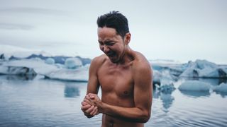 A man taking an icy plunge in Iceland