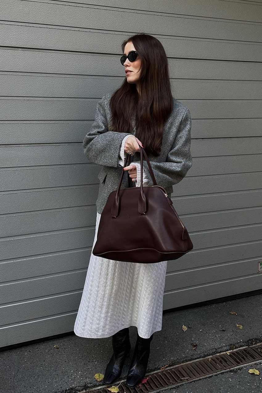 Woman wearing a knit dress and boots.