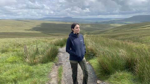 Julia Clarke in the Yorkshire Dales wearing the Montane Fireball Lite Hoodie with hands in pockets
