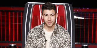 nick jonas sitting in his chair on the voice