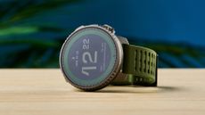 an outdoor-style smartwatch with a big screen and titanium bezel case with a forest green strap