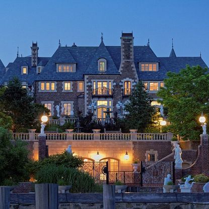 mansion with night view and outdoor lamp with statues