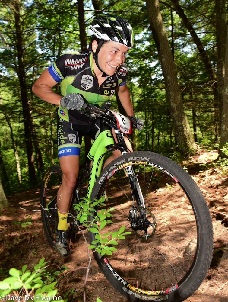 Crystal Anthony (Riverside Racing) smiling on a steep climb during lap two