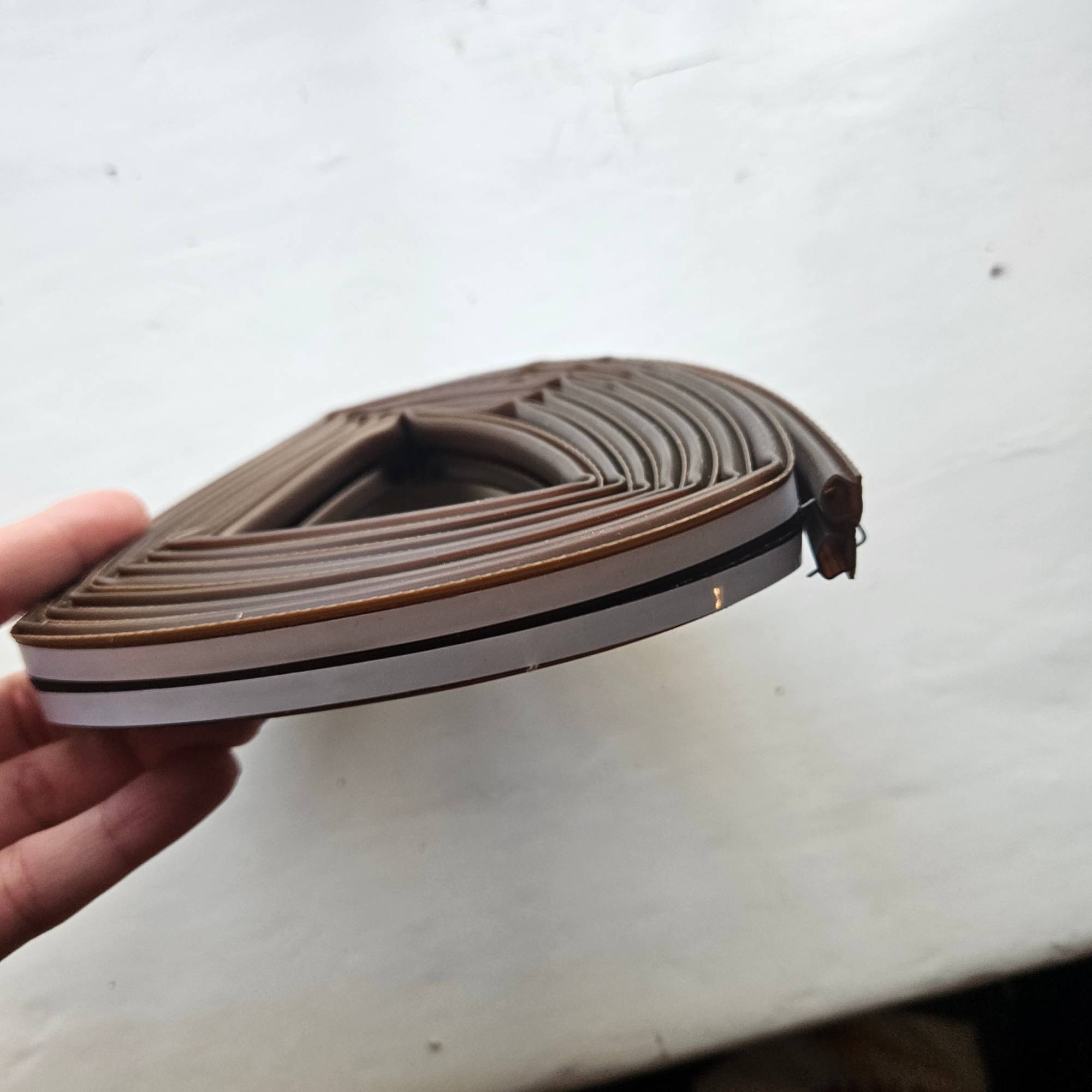 brown draught proofing tape in a coil