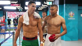 Cristiano Ronaldo and Kylian Mbappe talk, topless, and in their countries' coloured shorts, at the European Championships.