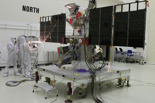 Engineers test the solar arrays on the NOAA/NASA Deep Space Climate Observatory, a satellite designed to serve as an early warning system for solar storms launching in February 2015.