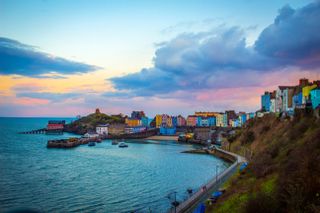 the beach in Tenby, Wales with houses in the background, by Beata Mitrega