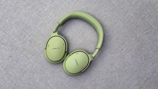 The Bose QuietComfort Headphones (2nd Gen) flat down on a gray fabric.