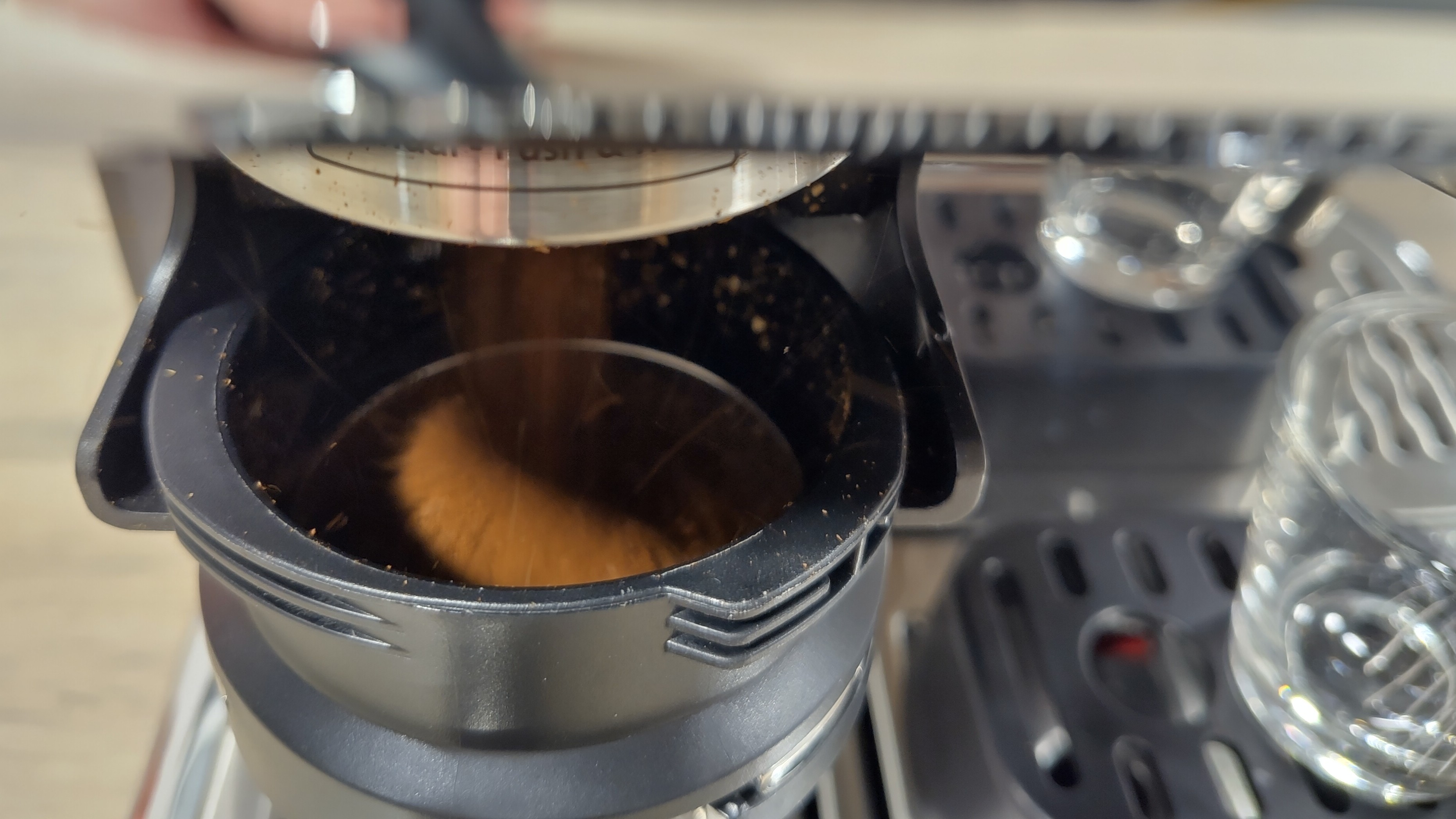 Philips Barista Brew coffee maker grinding coffee into portafilter handle