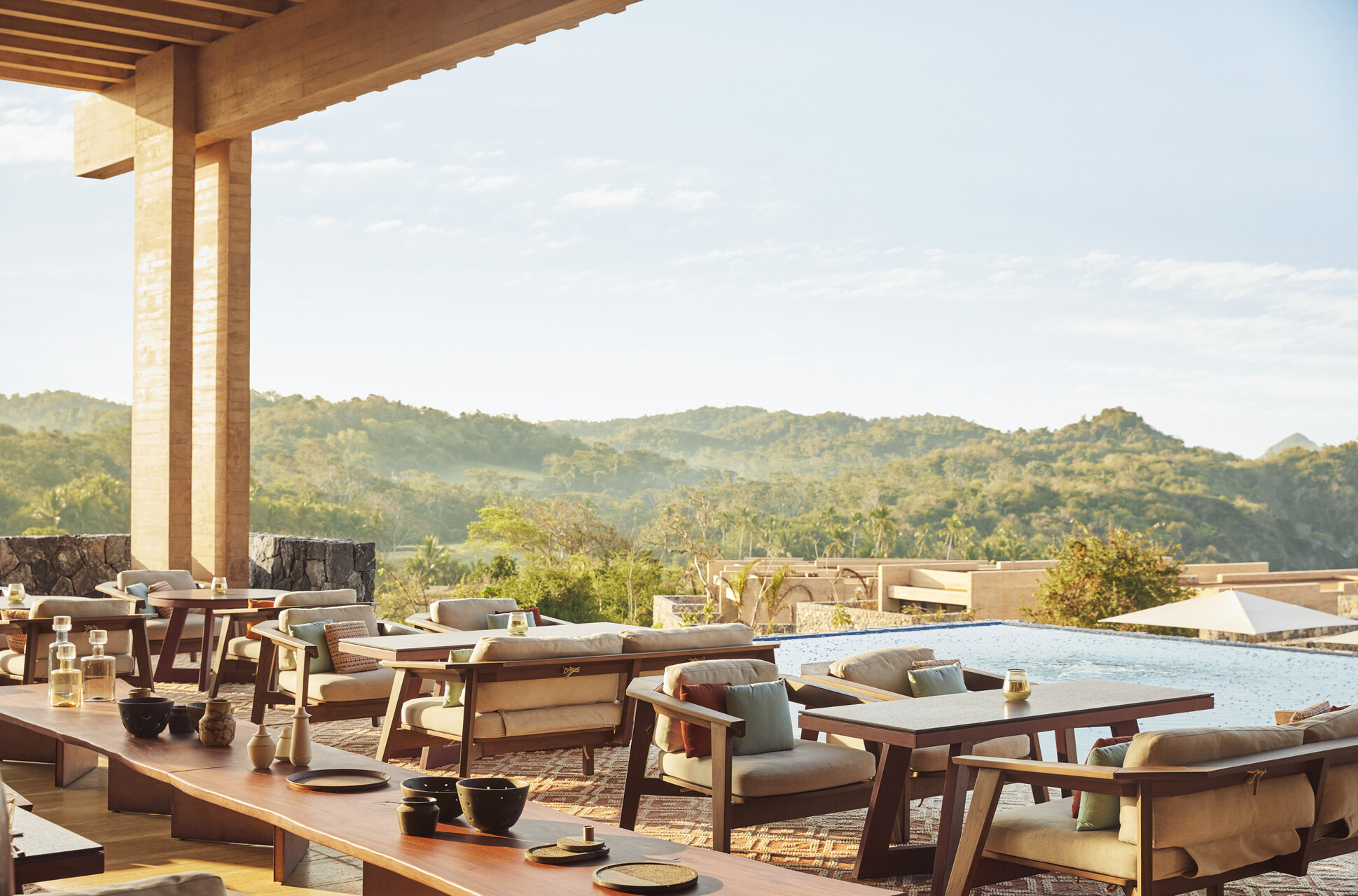 Four Seasons Tamarindo's restaurant Coyul during the day. Featuring expansive space, tan, tonal interiors and stones accents in an indoor-outdoor setting.