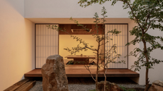 A home with an engawa, paper screens, a gravel garden, and a rock