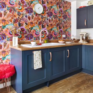 Colourful patterned wallpaper in kitchen, blue cabinetry